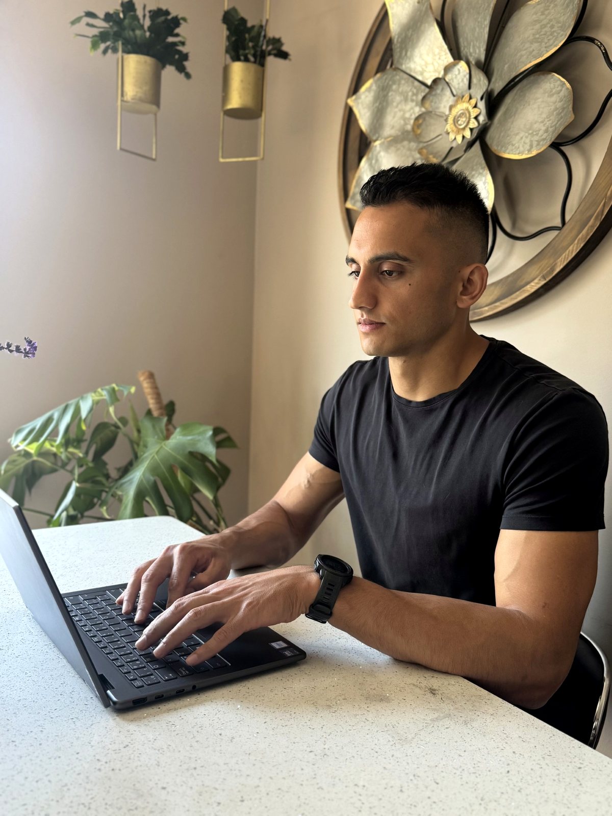 Abhi Mittu programming client training blocks at his laptop