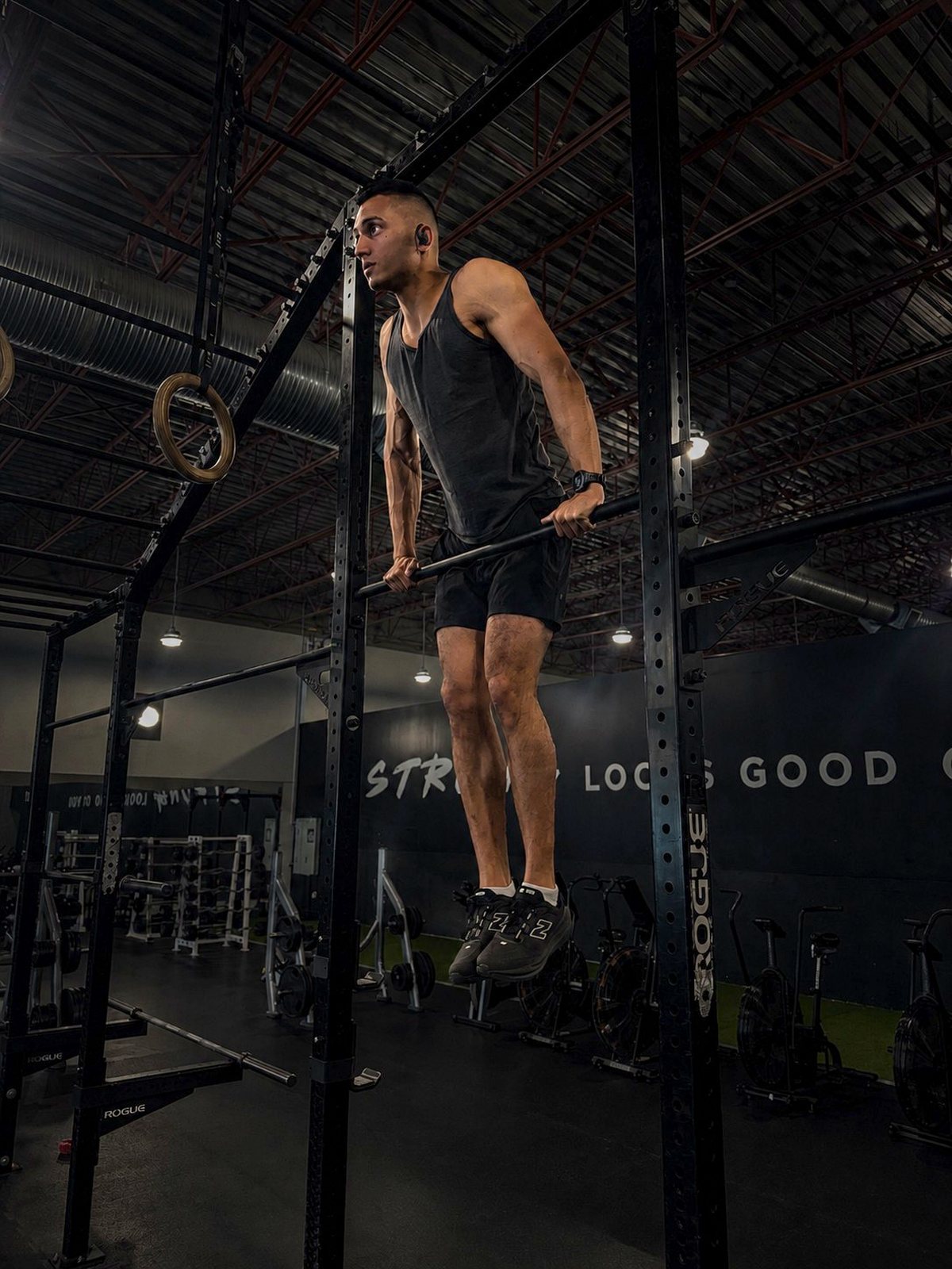 Abhi Mittu at the top of a dip on the gym rig